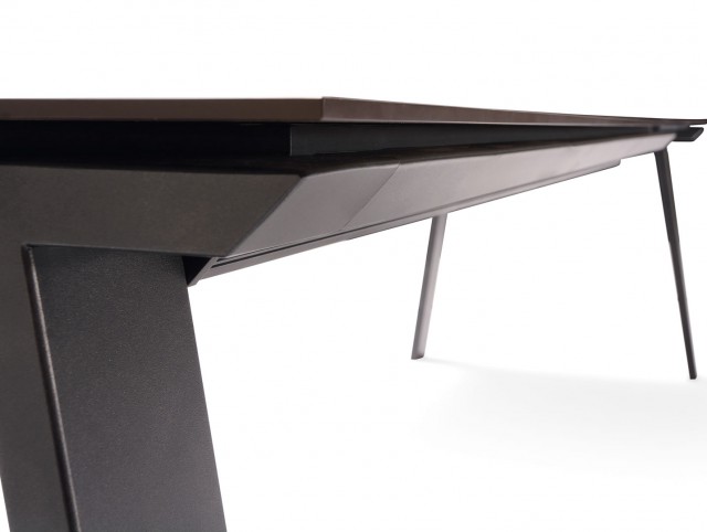 Detail of the side piece that joins the two legs giving continuity to the design of the table